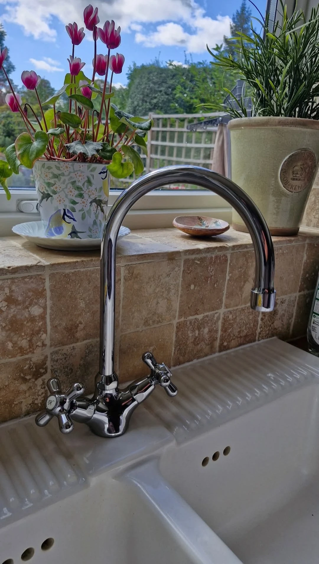 New chrome mixer tap on kitchen sink.